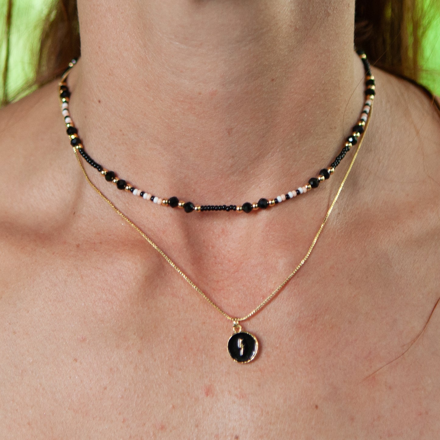 Fun necklace with various shapes, crafted from beads and rhodium chain The necklace is crafted with precision and quality, with various shapes made from durable beads and rhodium chain that will last for years to come.