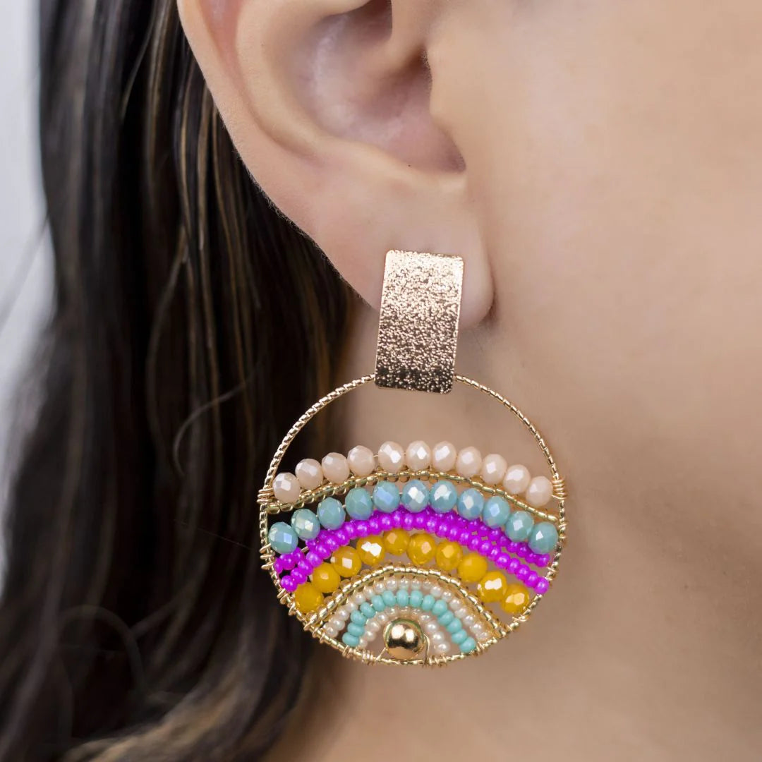 Expertly crafted by hand, these Mountains Earrings are a must-have for any fashion-conscious individual. Featuring bronze studs with stunning gold plating and unique beads on wire, these earrings add a touch of elegance to any outfit. Available in a variety of colors, they are the perfect accessory for every occasion.