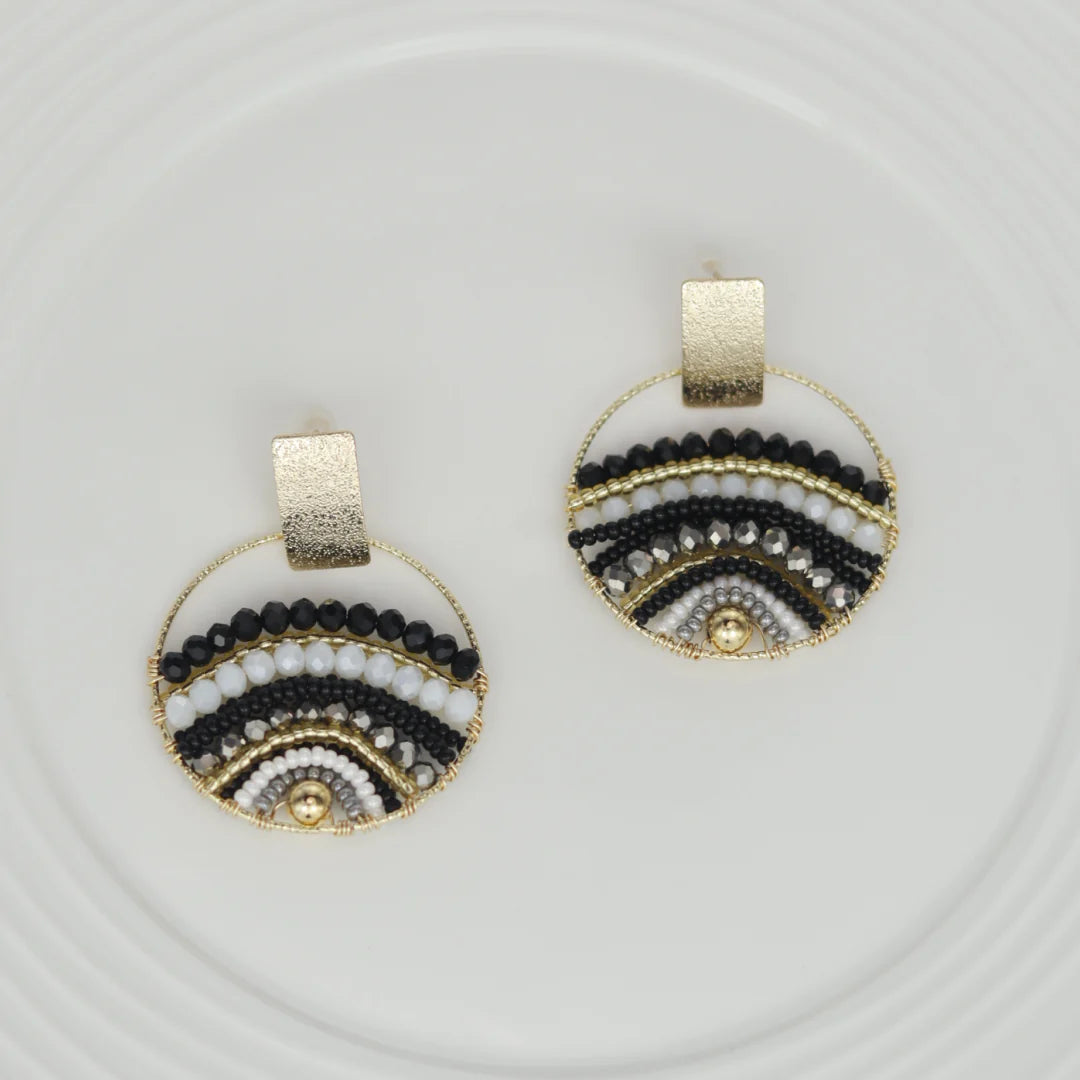 Expertly crafted by hand, these Mountains Earrings are a must-have for any fashion-conscious individual. Featuring bronze studs with stunning gold plating and unique beads on wire, these earrings add a touch of elegance to any outfit. Available in a variety of colors, they are the perfect accessory for every occasion.