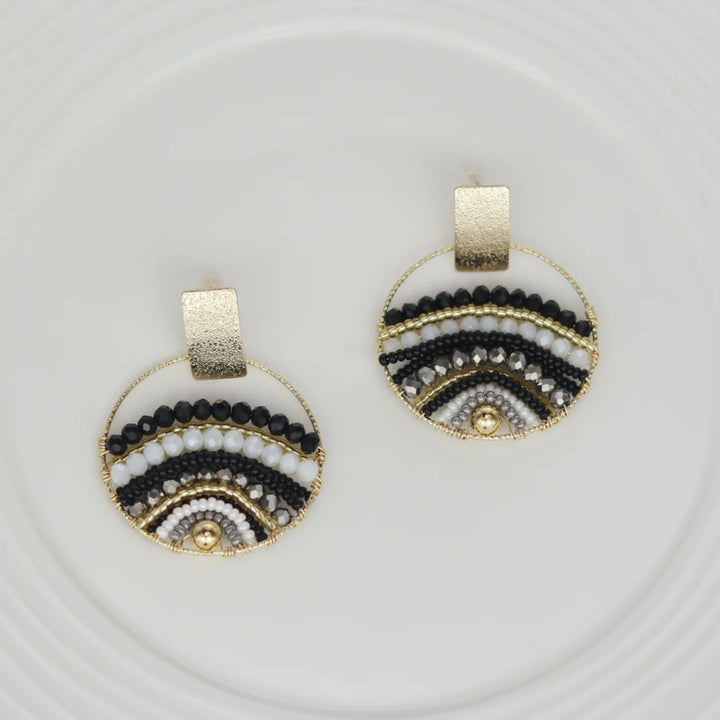 Expertly crafted by hand, these Mountains Earrings are a must-have for any fashion-conscious individual. Featuring bronze studs with stunning gold plating and unique beads on wire, these earrings add a touch of elegance to any outfit. Available in a variety of colors, they are the perfect accessory for every occasion.