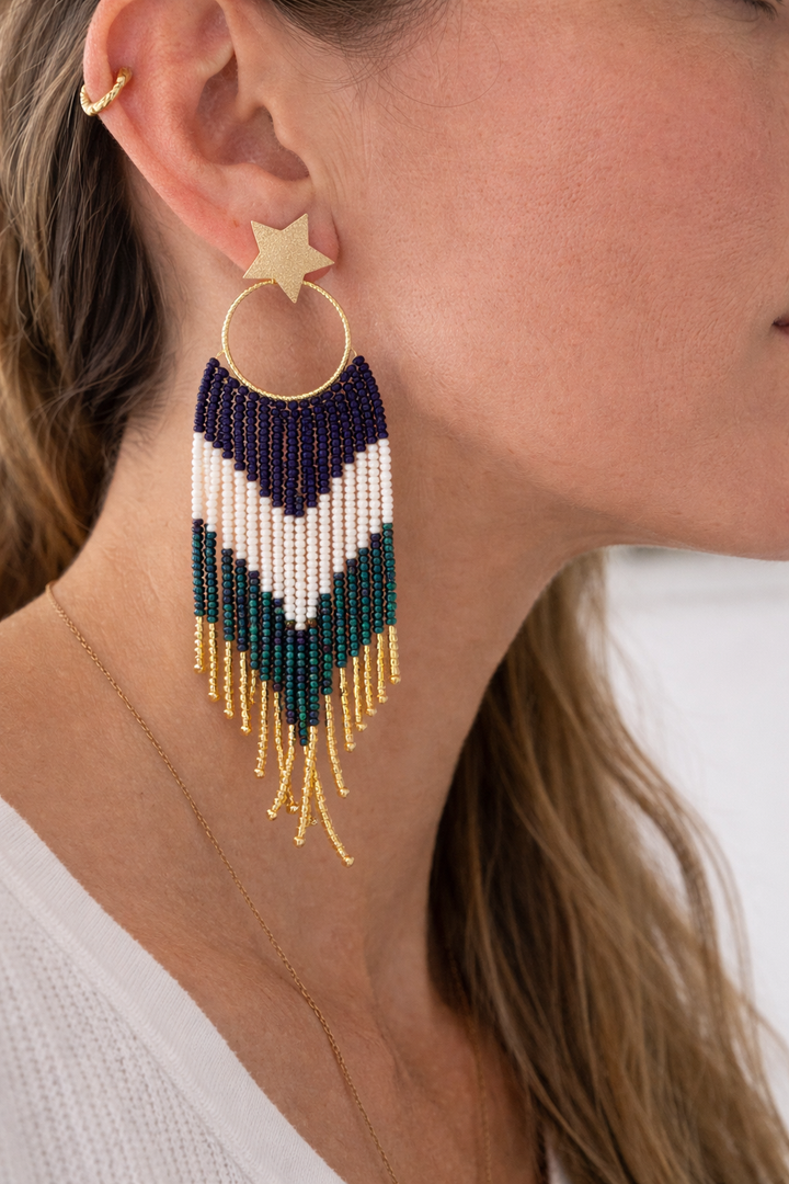 Close-up of a beaded earring with a star detail.