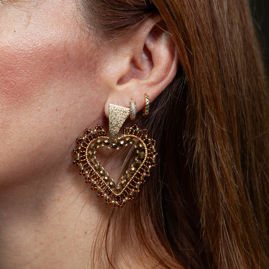 Expertly crafted by hand, our Lovely Heath Earrings feature dazzling beads on delicate wire, accented with a bronze stud and luxurious gold plating. Available in a variety of stunning colors, these earrings are the perfect statement piece for any occasion. Elevate your style with these unique and beautifully designed earrings.
