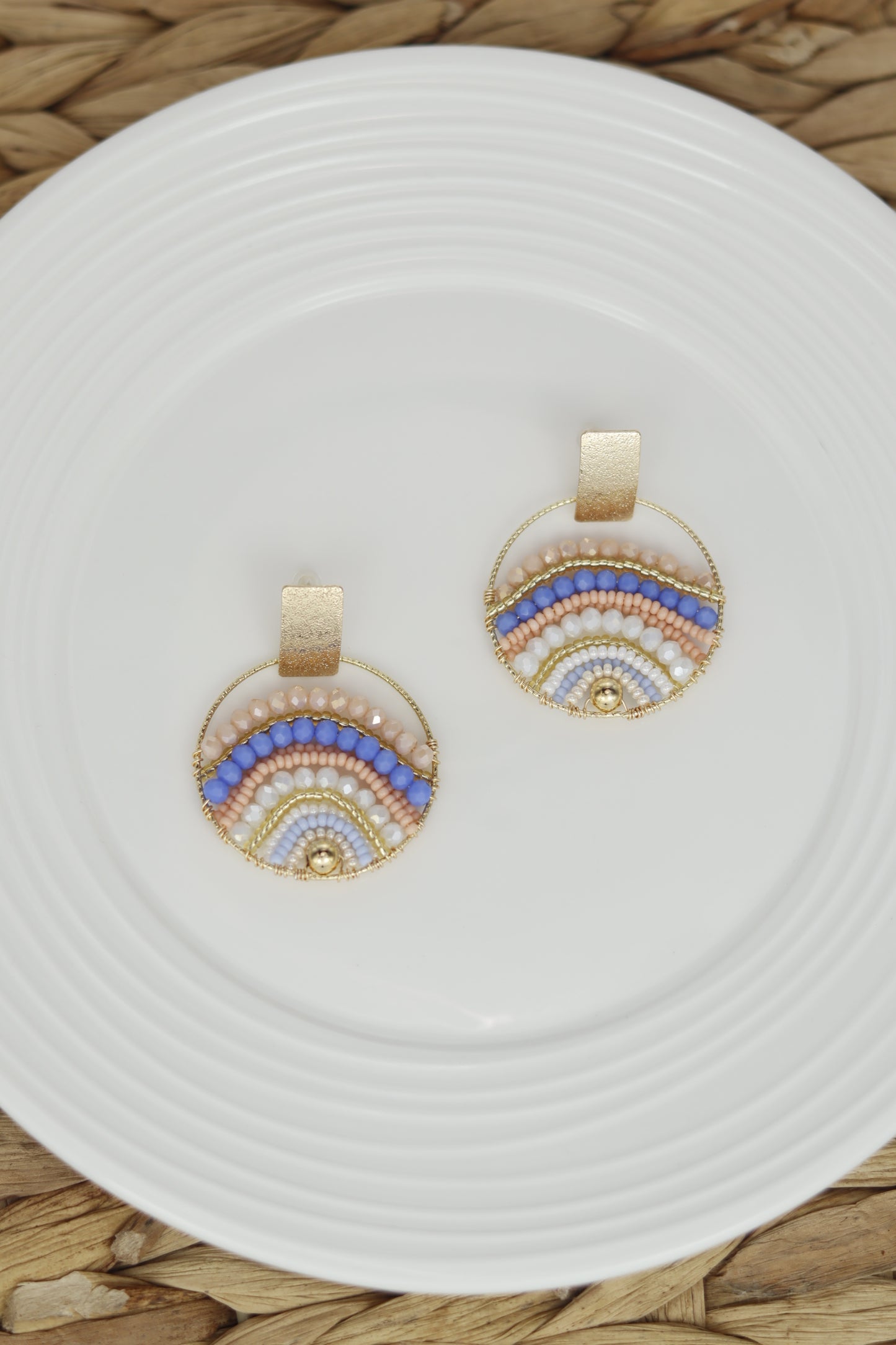 Expertly crafted by hand, these Mountains Earrings are a must-have for any fashion-conscious individual. Featuring bronze studs with stunning gold plating and unique beads on wire, these earrings add a touch of elegance to any outfit. Available in a variety of colors, they are the perfect accessory for every occasion.