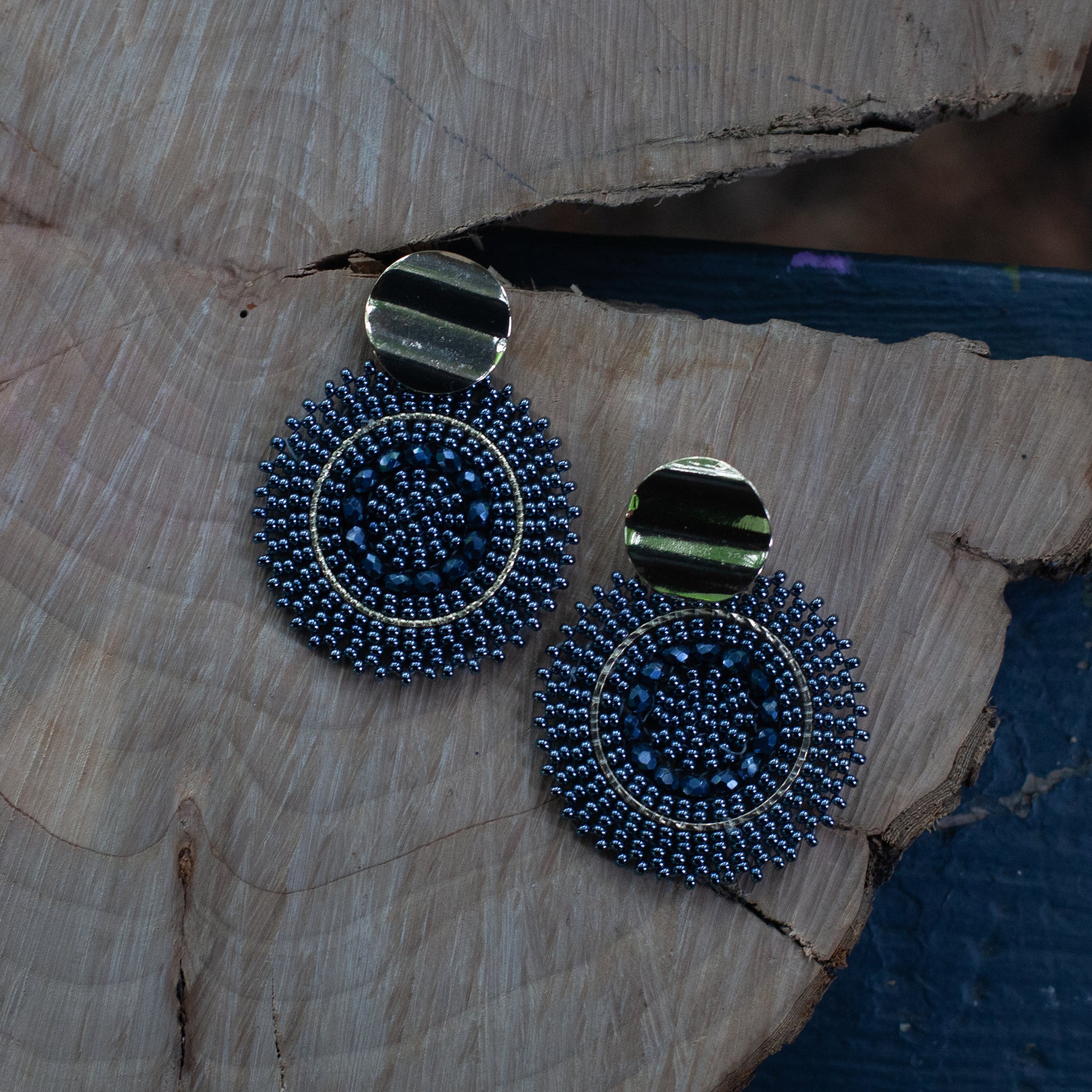 These earrings are handcrafted with colorful beadwork on a delicate wire and feature a bronze stud with a gleaming gold plating, available in a variety of colors.