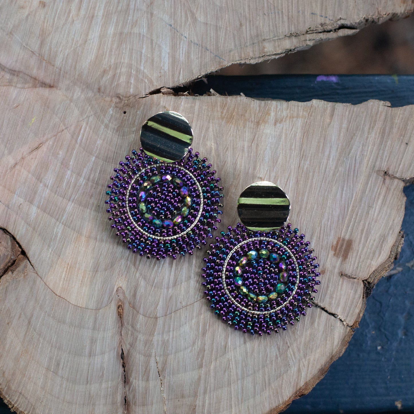 These earrings are handcrafted with colorful beadwork on a delicate wire and feature a bronze stud with a gleaming gold plating, available in a variety of colors.
