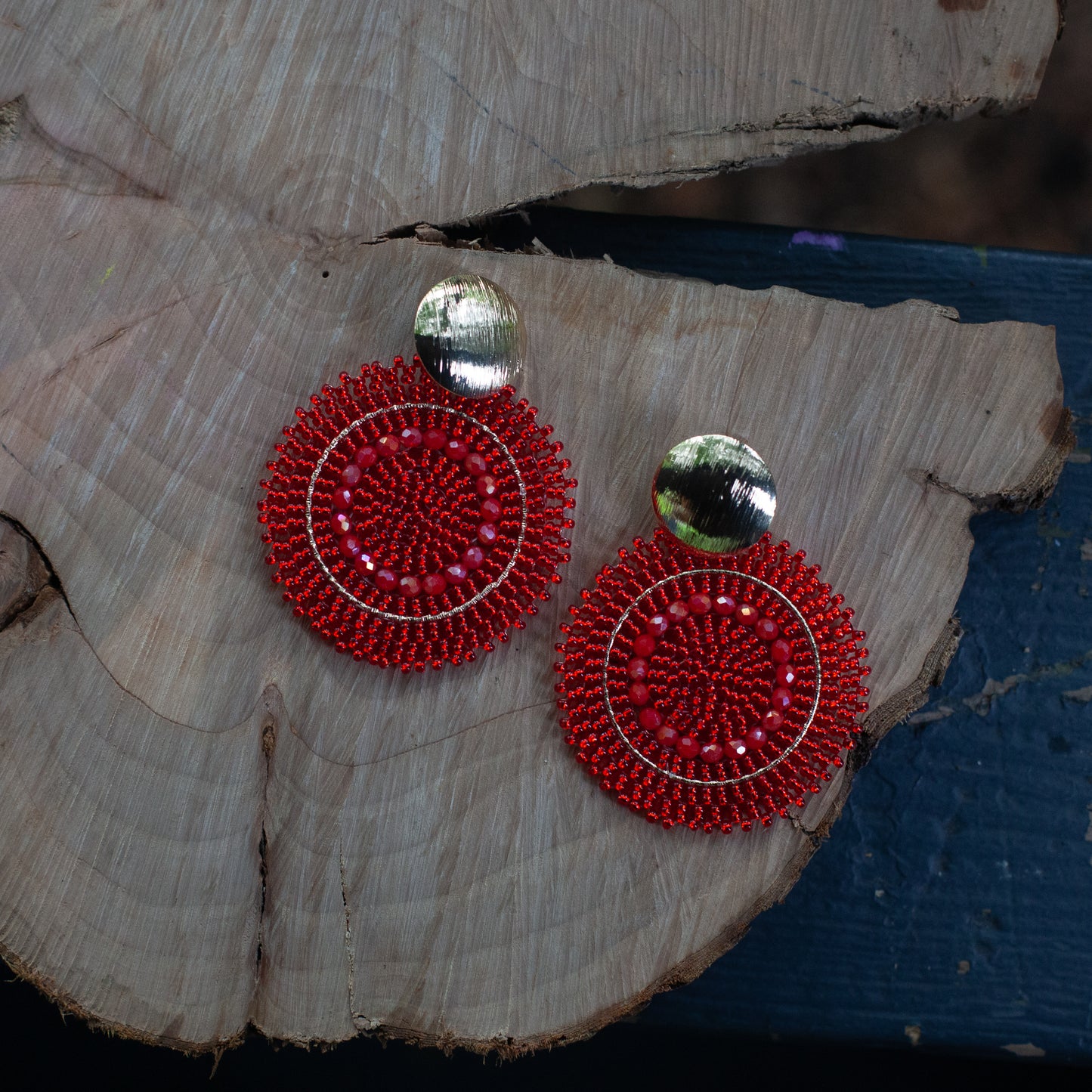 These earrings are handcrafted with colorful beadwork on a delicate wire and feature a bronze stud with a gleaming gold plating, available in a variety of colors.