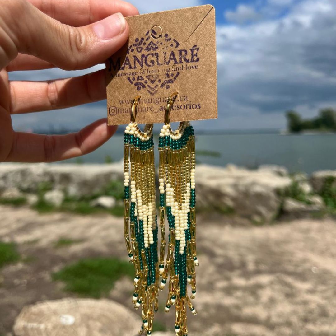 Dangling earrings handmade with beads on wire, featuring a bronze stud with gold plating, available in various colors. Handmade with the highest quality materials, these earrings are truly unique. Each pair features a variety of colors to match any outfit and every occasion.