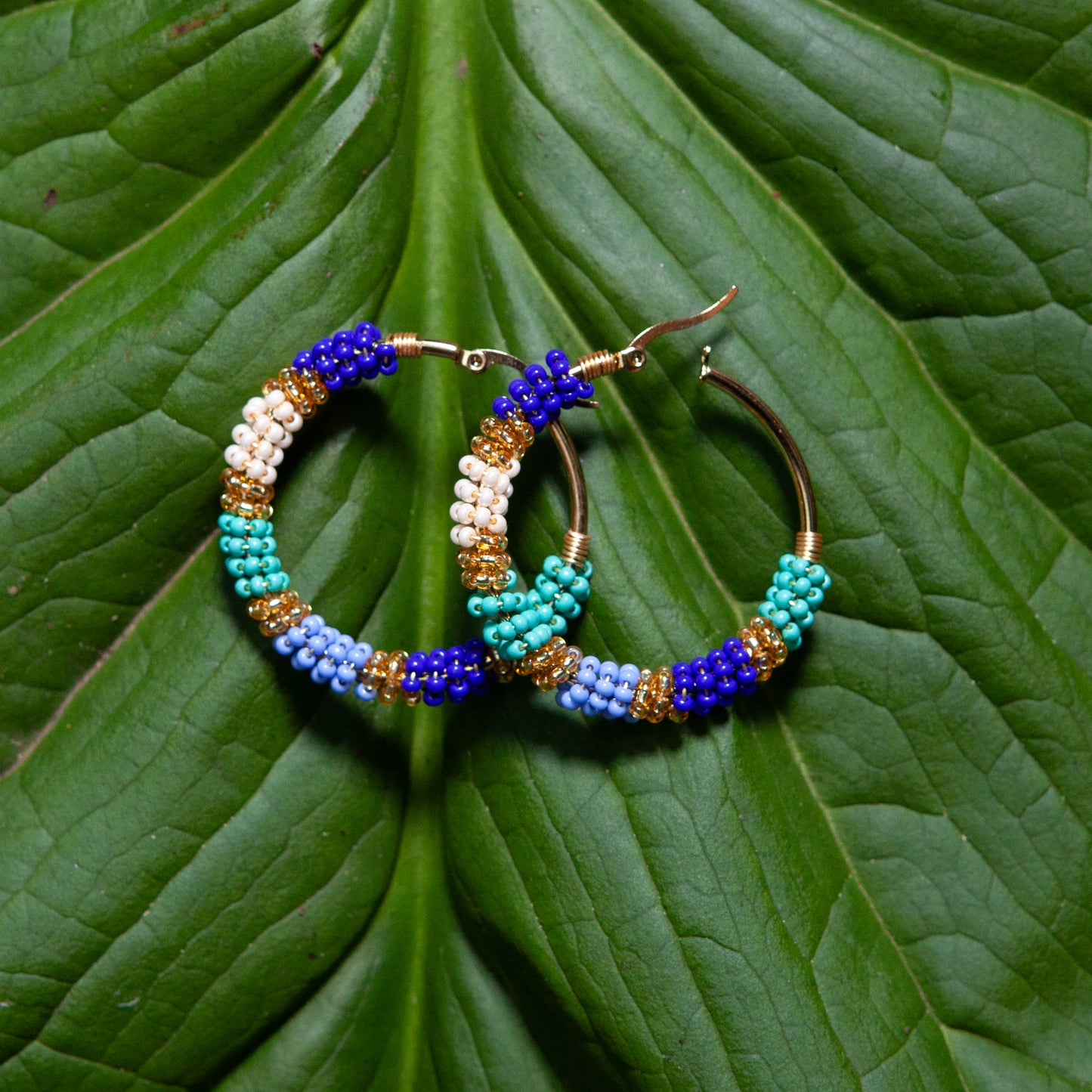 Handmade earrings with beads on wire, featuring a bronze stud with gold plating, available in various colors