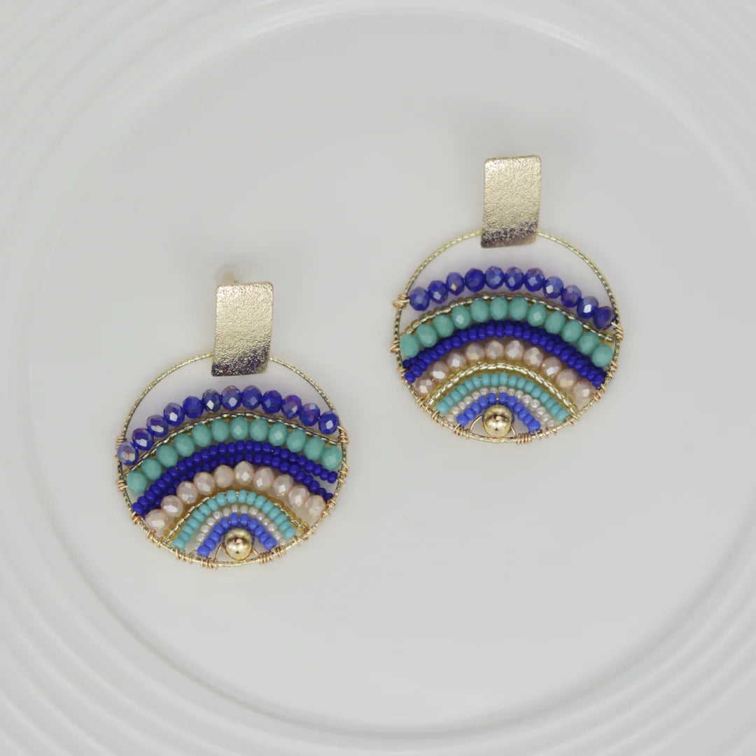 Expertly crafted by hand, these Mountains Earrings are a must-have for any fashion-conscious individual. Featuring bronze studs with stunning gold plating and unique beads on wire, these earrings add a touch of elegance to any outfit. Available in a variety of colors, they are the perfect accessory for every occasion.
