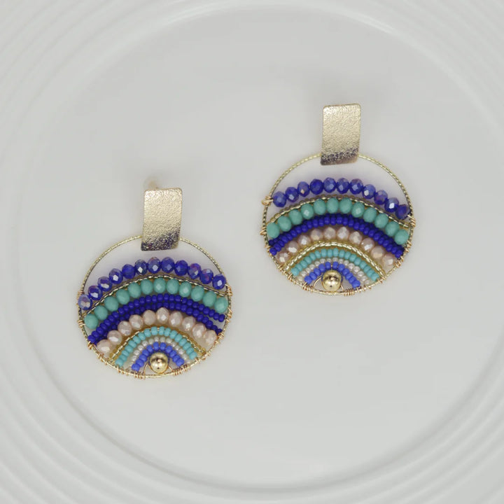 Expertly crafted by hand, these Mountains Earrings are a must-have for any fashion-conscious individual. Featuring bronze studs with stunning gold plating and unique beads on wire, these earrings add a touch of elegance to any outfit. Available in a variety of colors, they are the perfect accessory for every occasion.