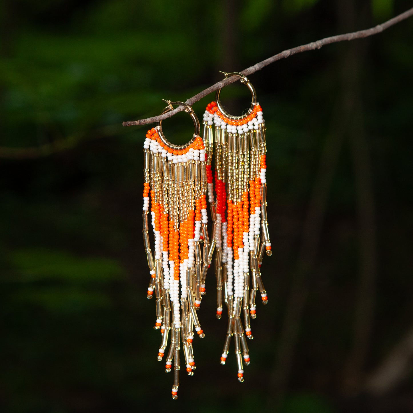 Dangling earrings handmade with beads on wire, featuring a bronze stud with gold plating, available in various colors. Handmade with the highest quality materials, these earrings are truly unique. Each pair features a variety of colors to match any outfit and every occasion.