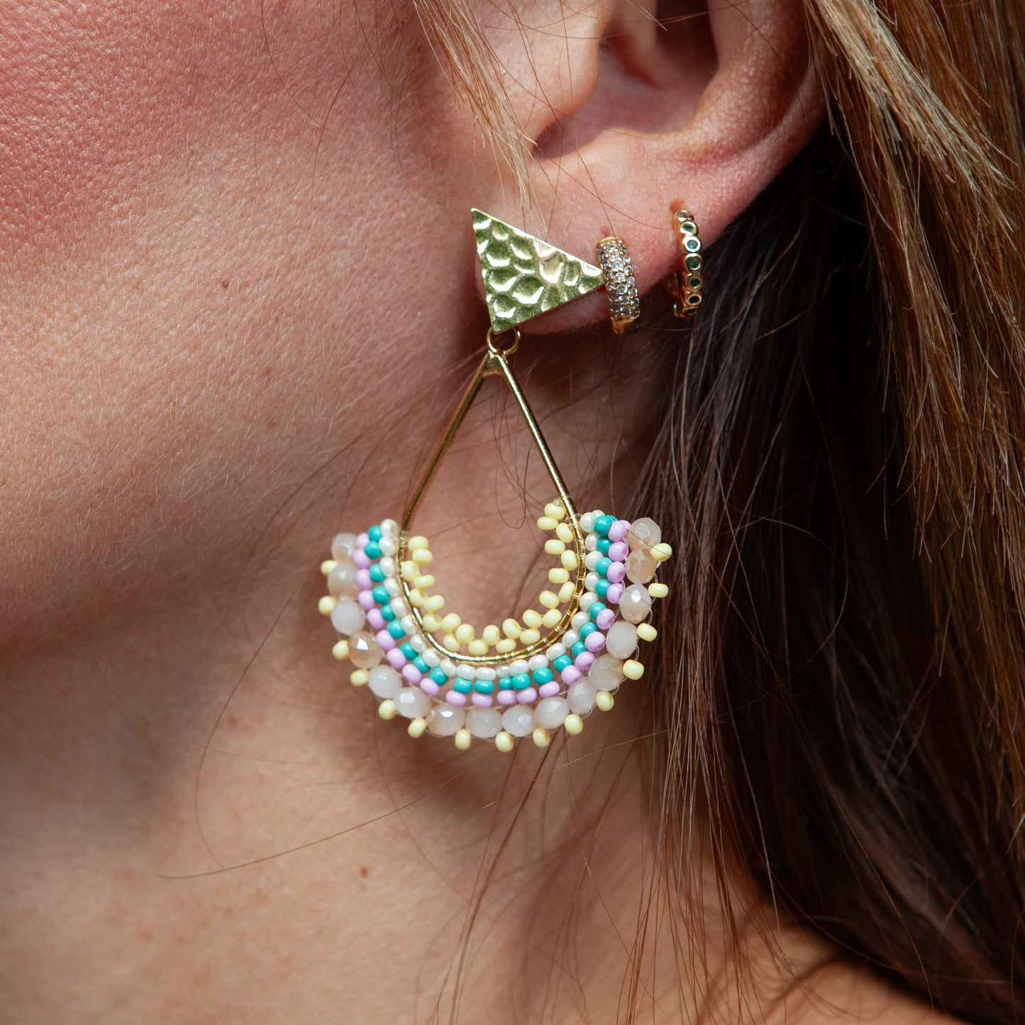 Each pair features unique beadwork and a bronze stud with gold plating, available in an array of stunning colors. Elevate your style with our Fan-Shaped Earrings.