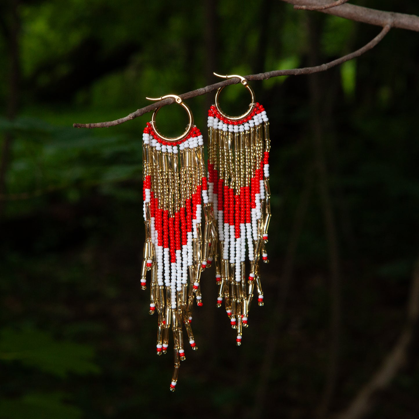Dangling earrings handmade with beads on wire, featuring a bronze stud with gold plating, available in various colors. Handmade with the highest quality materials, these earrings are truly unique. Each pair features a variety of colors to match any outfit and every occasion.