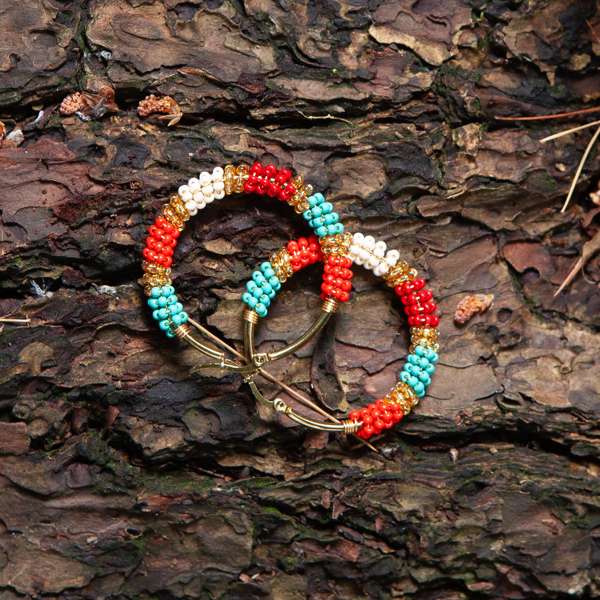 Handmade earrings with beads on wire, featuring a bronze stud with gold plating, available in various colors