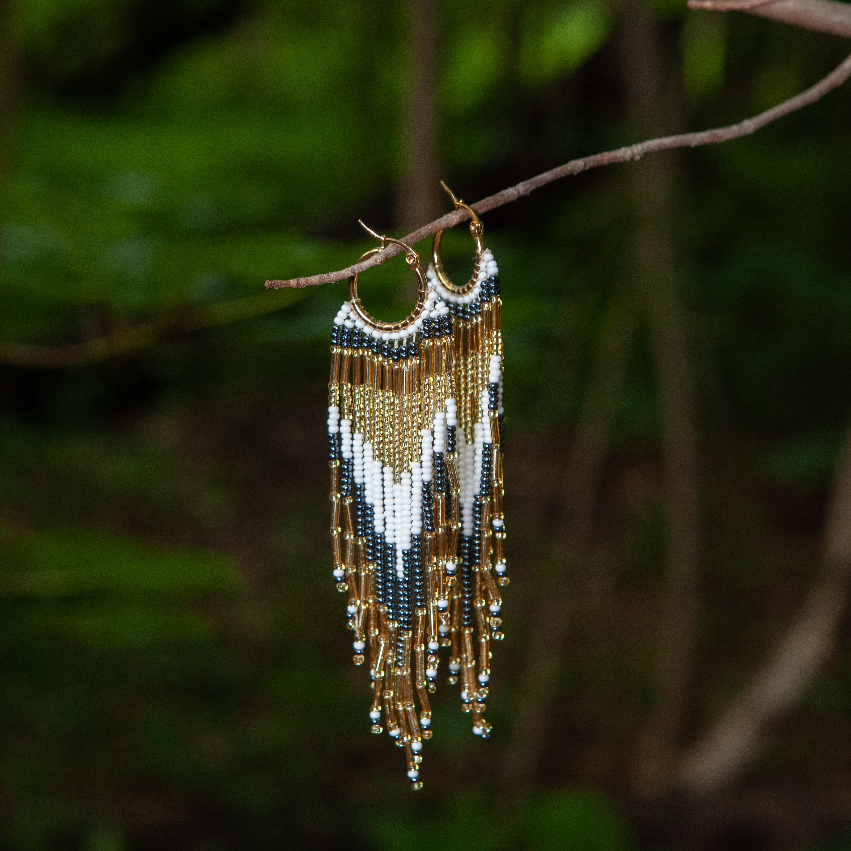 Dangling earrings handmade with beads on wire, featuring a bronze stud with gold plating, available in various colors. Handmade with the highest quality materials, these earrings are truly unique. Each pair features a variety of colors to match any outfit and every occasion.