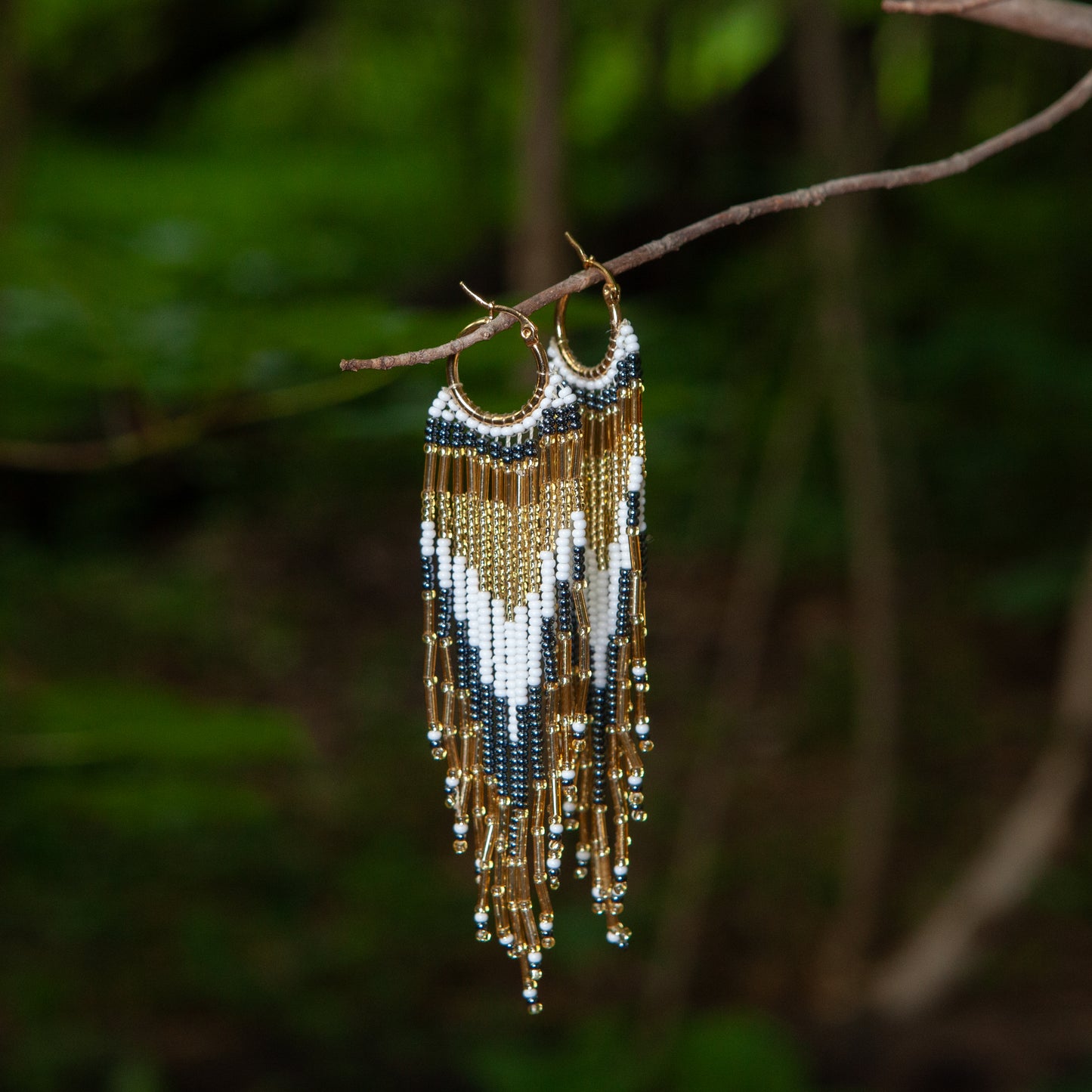 Dangling earrings handmade with beads on wire, featuring a bronze stud with gold plating, available in various colors. Handmade with the highest quality materials, these earrings are truly unique. Each pair features a variety of colors to match any outfit and every occasion.